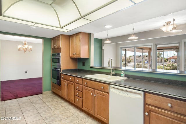 kitchen featuring dishwasher, pendant lighting, a notable chandelier, double oven, and sink