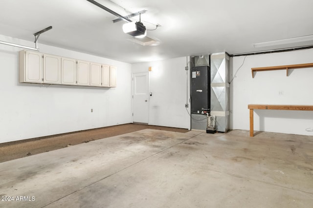 garage featuring a garage door opener and heating unit