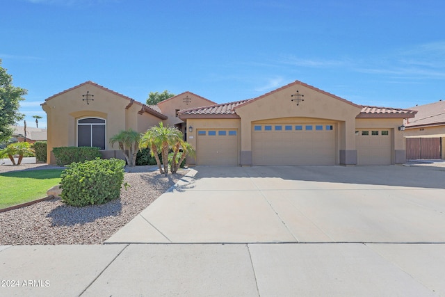 mediterranean / spanish-style home featuring a garage