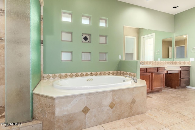 full bathroom with tile patterned floors, a garden tub, vanity, and a tile shower