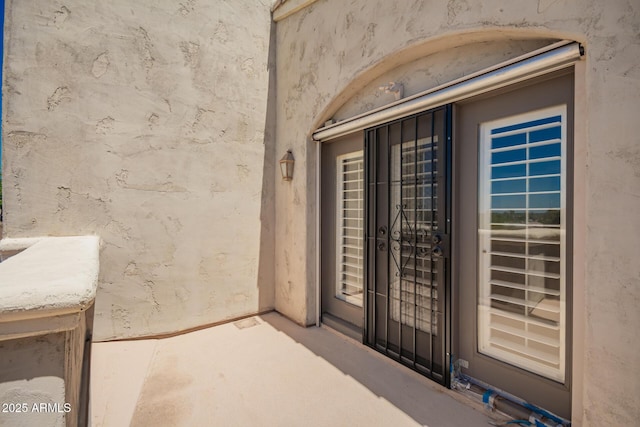 doorway to property with stucco siding
