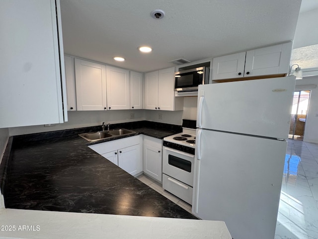 kitchen with sink, white appliances, and white cabinets