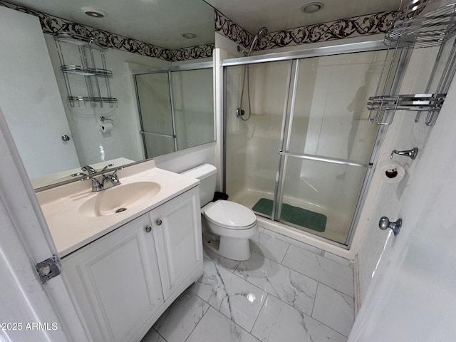 bathroom with vanity, toilet, and walk in shower