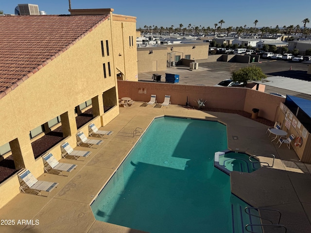 view of pool with a patio area, central AC unit, and a hot tub