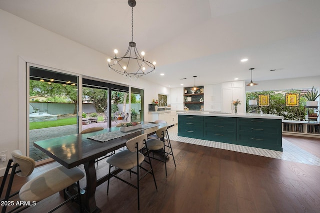 dining area with a notable chandelier, dark wood-type flooring, and recessed lighting