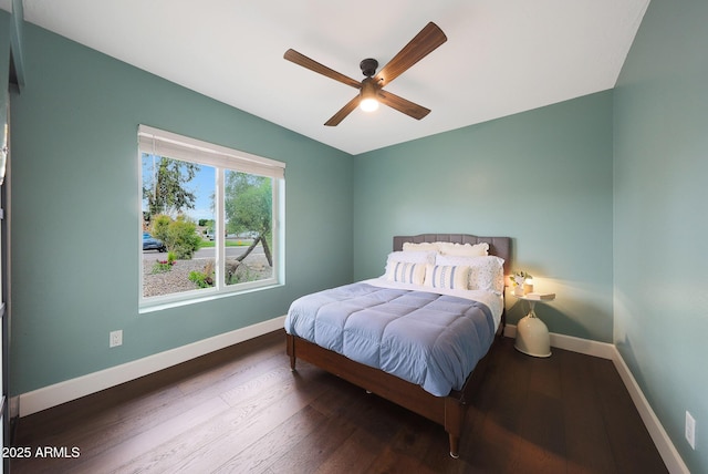 bedroom with wood finished floors, a ceiling fan, and baseboards