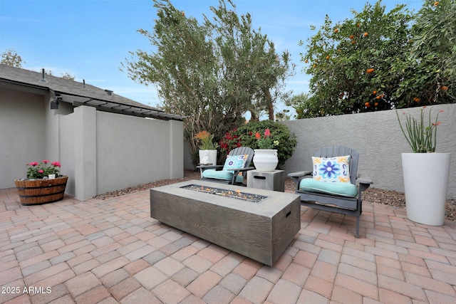 view of patio / terrace featuring an outdoor fire pit and fence