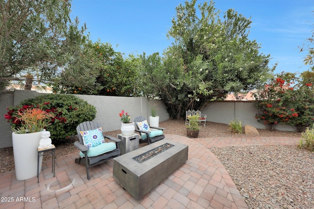 view of patio featuring an outdoor fire pit and a fenced backyard