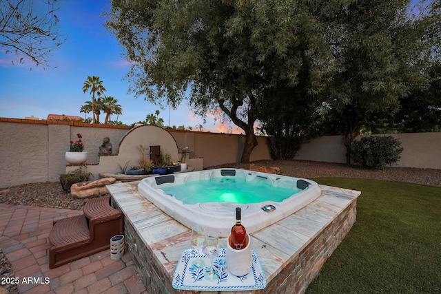 view of pool featuring a fenced backyard and hot tub deck surround