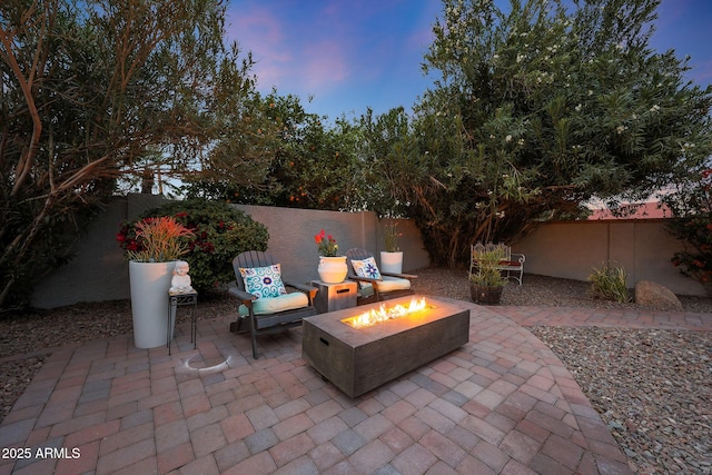 view of patio with an outdoor fire pit and a fenced backyard