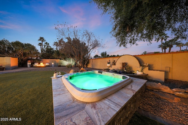 view of pool featuring a yard, a fenced backyard, hot tub deck surround, and a patio