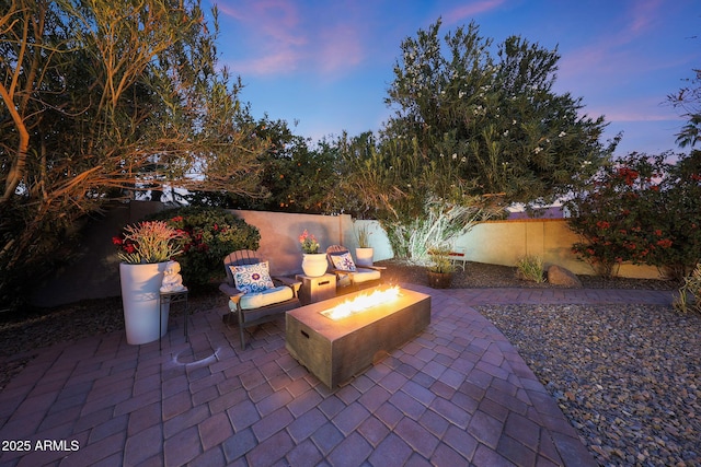 view of patio / terrace with an outdoor fire pit and a fenced backyard