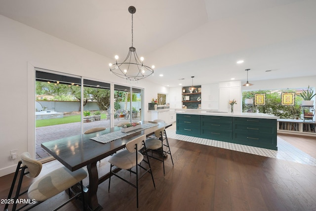 dining space with lofted ceiling, dark wood-style floors, an inviting chandelier, and recessed lighting