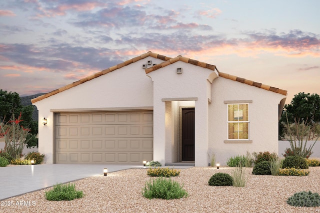 mediterranean / spanish-style house featuring stucco siding, a garage, driveway, and a tiled roof