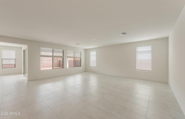 unfurnished room featuring a wealth of natural light and light tile patterned flooring