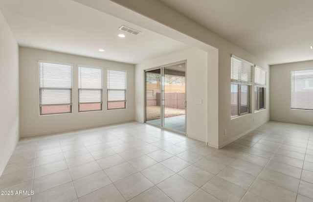 tiled spare room with a healthy amount of sunlight