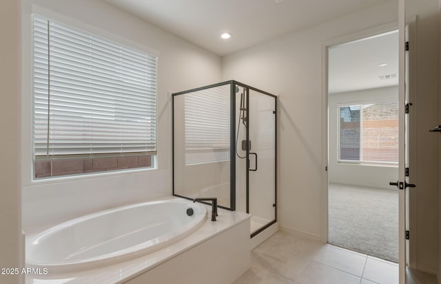 bathroom with independent shower and bath and tile patterned flooring