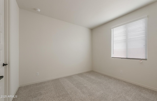 spare room featuring light colored carpet