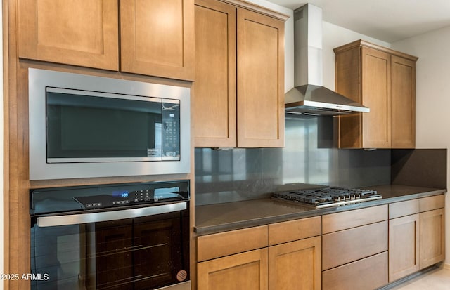 kitchen featuring stainless steel appliances, decorative backsplash, and wall chimney exhaust hood