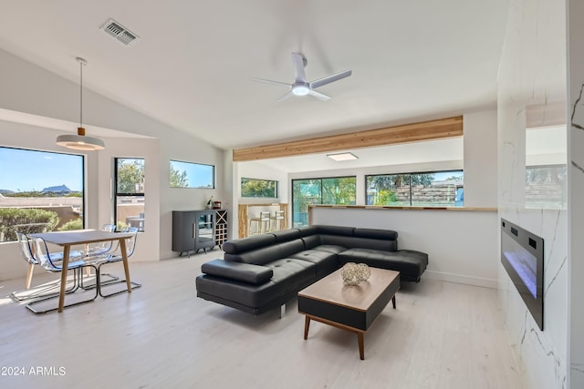 living room featuring lofted ceiling with beams, wood-type flooring, and ceiling fan