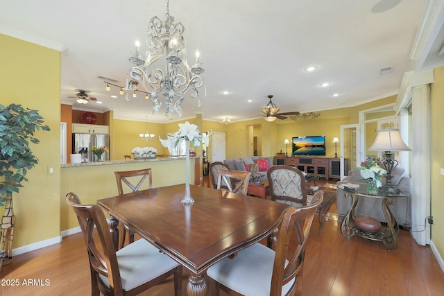 dining area with ceiling fan, light hardwood / wood-style flooring, and crown molding