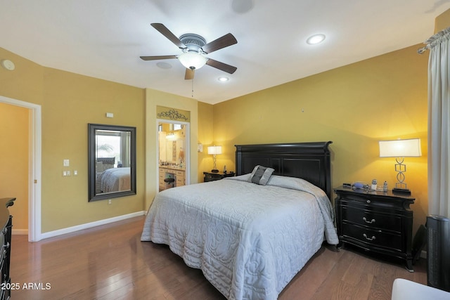 bedroom featuring ceiling fan, connected bathroom, and hardwood / wood-style flooring