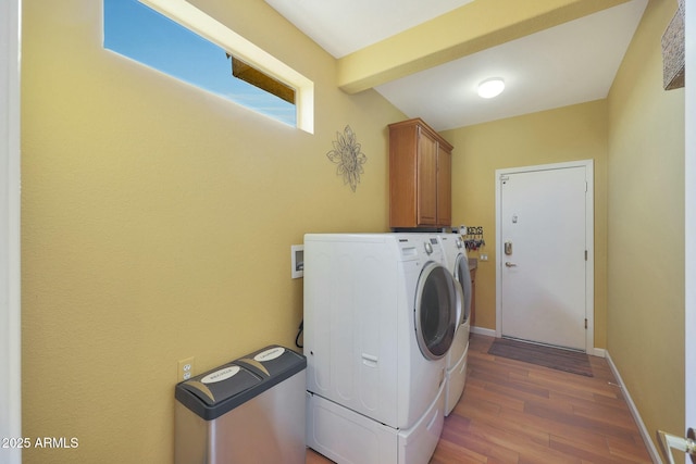 laundry area with cabinets, washer and clothes dryer, and dark hardwood / wood-style flooring