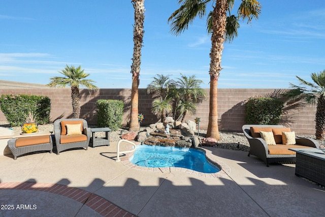 view of pool with pool water feature and a patio area