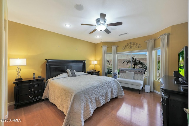 bedroom with ceiling fan and dark hardwood / wood-style flooring