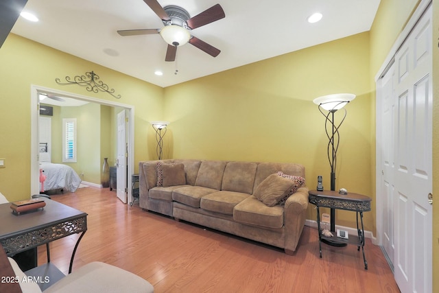 living room featuring ceiling fan and wood-type flooring