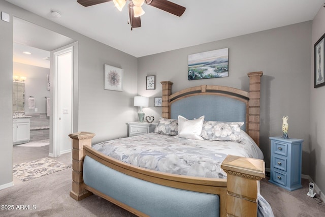 carpeted bedroom featuring connected bathroom, baseboards, and ceiling fan