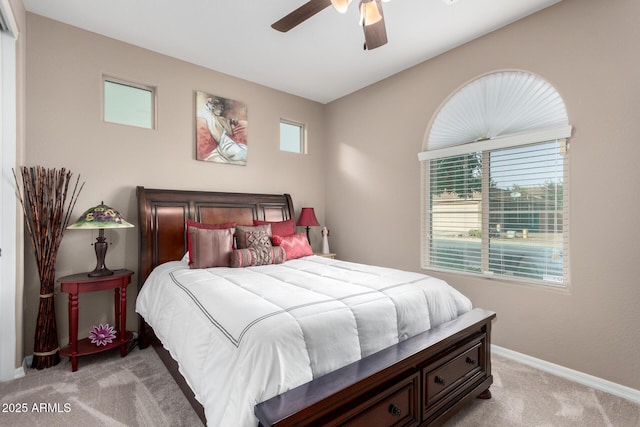 bedroom featuring ceiling fan, baseboards, and light colored carpet