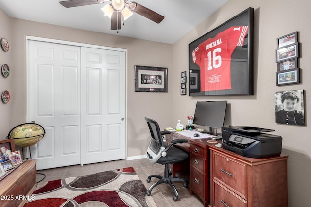 home office featuring a ceiling fan, tile patterned flooring, and baseboards