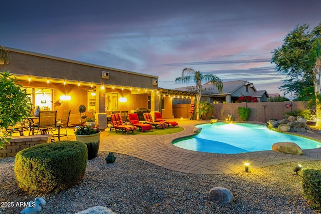 view of swimming pool with a fenced in pool, fence, and a patio