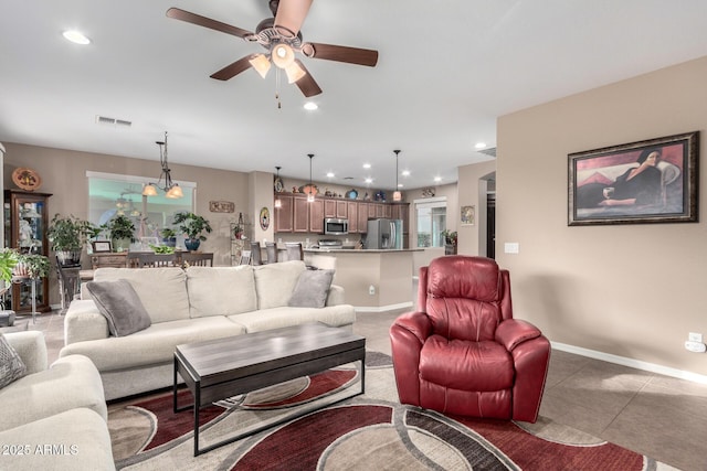 living area featuring baseboards, visible vents, ceiling fan, and recessed lighting