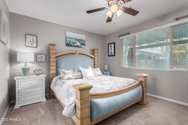 carpeted bedroom featuring a ceiling fan and baseboards