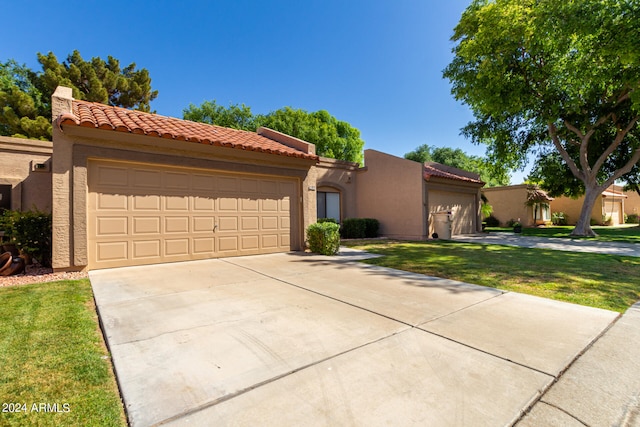 mediterranean / spanish-style home with a front yard