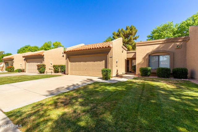 view of front of home with a garage and a front lawn