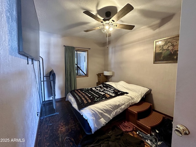 bedroom with wood-type flooring and ceiling fan