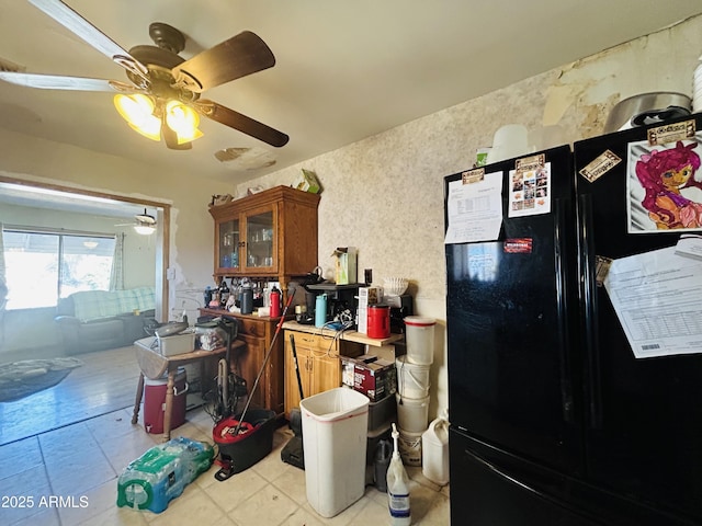 kitchen with ceiling fan and black fridge