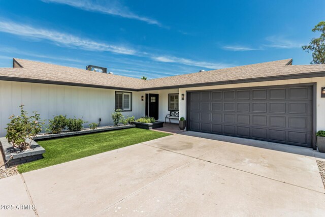 11215 N 38th Ave N, Phoenix, AZ 85029 - ranch-style house with driveway, a garage, a front yard, and roof with shingles