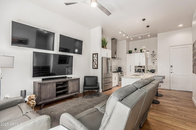 3131 N Central Ave Unit 7004, Phoenix, AZ 85012 - living room with light wood-style floors and a ceiling fan