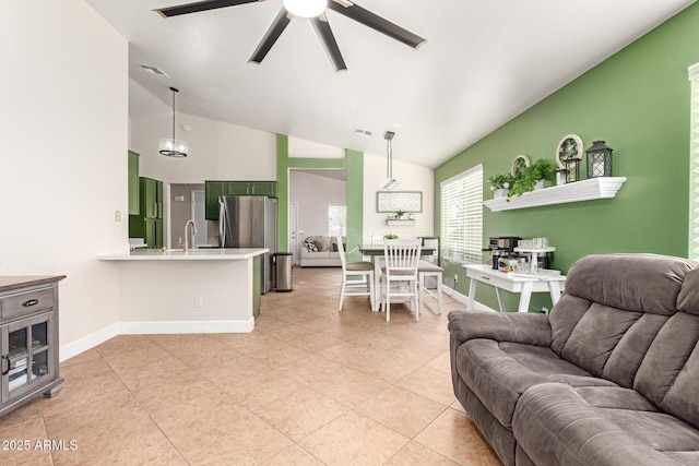 tiled living room featuring lofted ceiling, sink, and ceiling fan