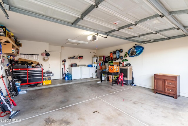 garage with a garage door opener, washer and dryer, and a workshop area