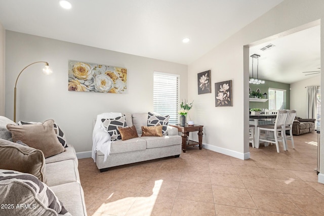 living room with light tile patterned flooring and lofted ceiling