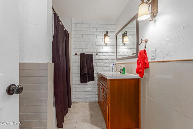 bathroom with vanity, curtained shower, and tile patterned flooring