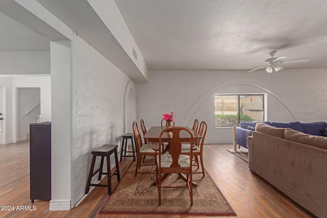 dining area featuring ceiling fan and dark hardwood / wood-style flooring