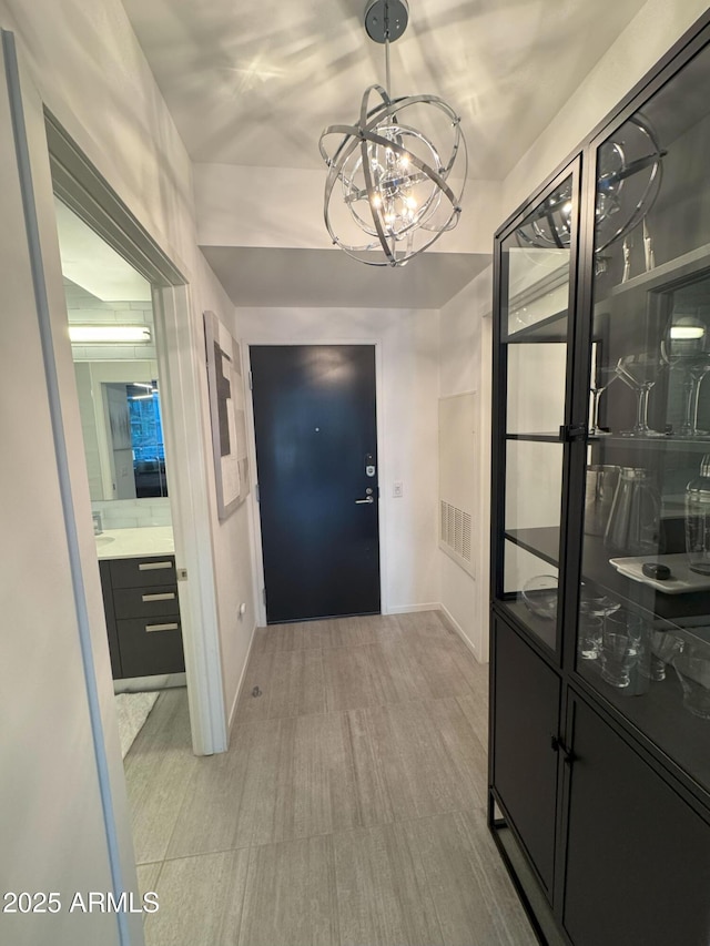 7120 E Kierland Blvd Unit 404, Scottsdale, AZ 85254 - entrance foyer featuring baseboards and a chandelier