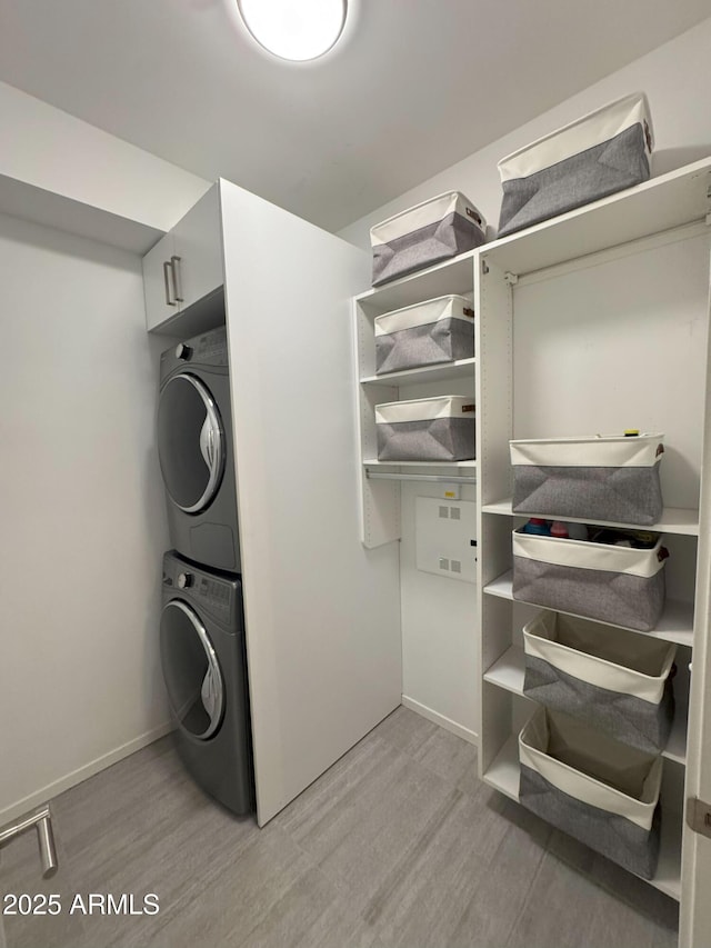 7120 E Kierland Blvd Unit 404, Scottsdale, AZ 85254 - laundry room with stacked washer / dryer and light wood-style floors