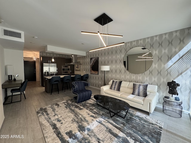 7120 E Kierland Blvd Unit 404, Scottsdale, AZ 85254 - living area featuring wallpapered walls and a chandelier